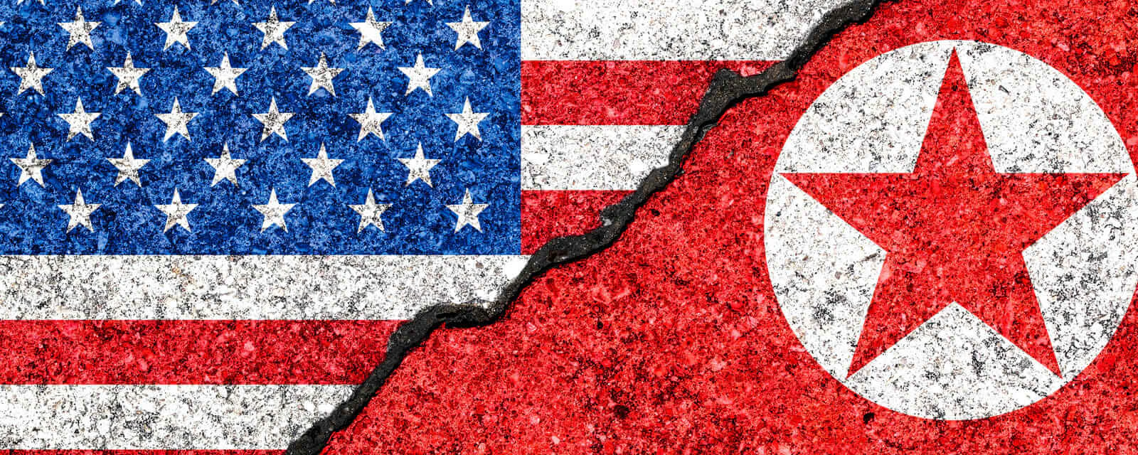 Flags of North Korea and USA painted on cracked wall background