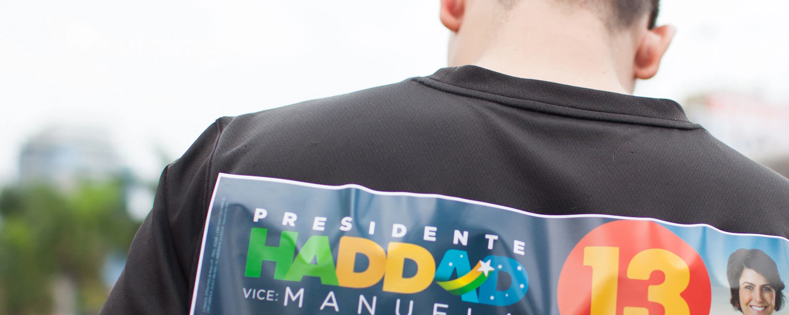 Man with Haddad's sticker on the back of his shirt